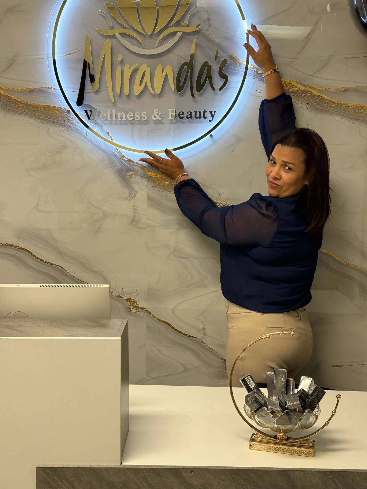 Nayrobis Miranda alongside the Miranda's Wellness & Beauty logo